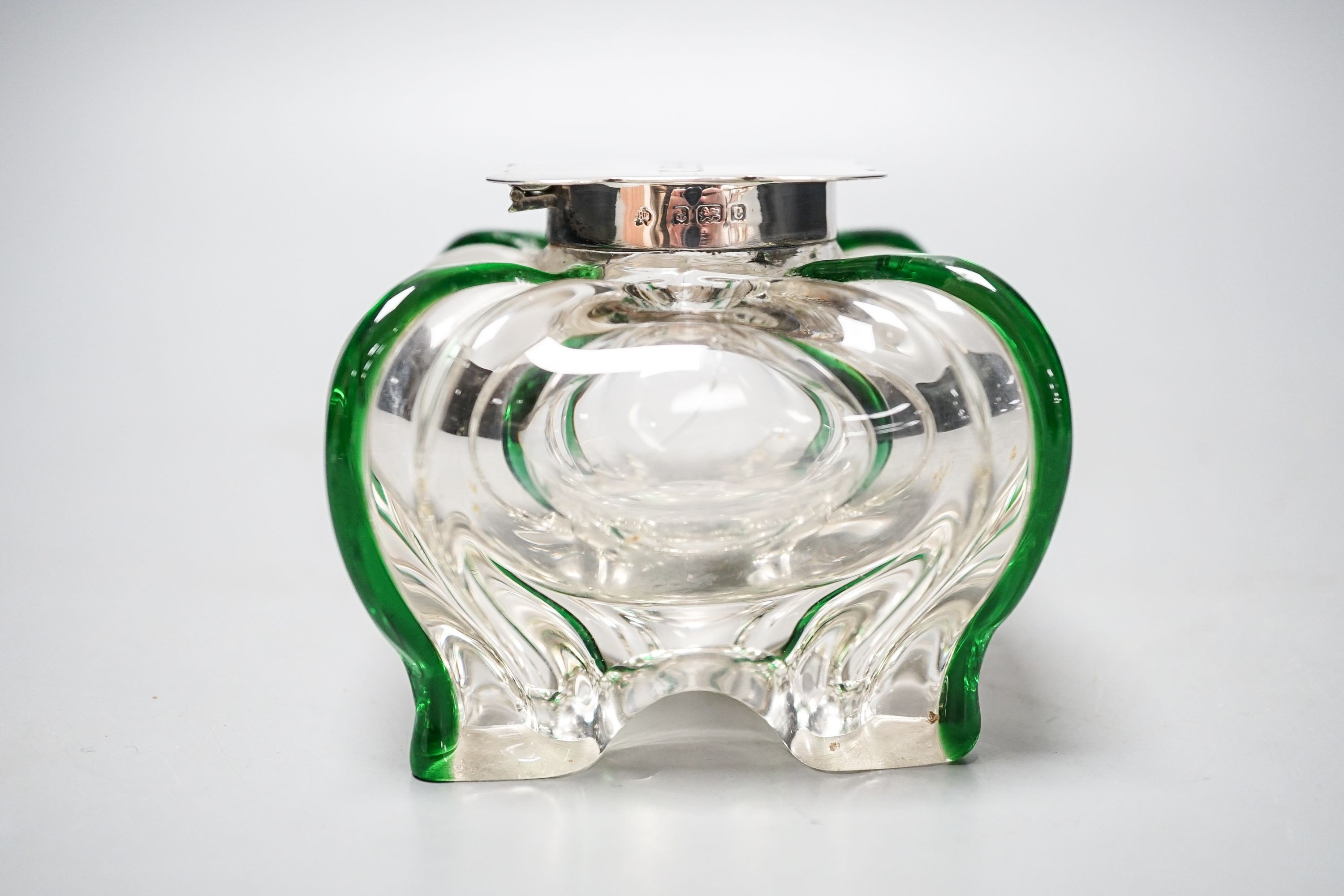 A silver-mounted green trailed glass inkwell, possibly Powell, Whitefriars. The lid initialled ‘G.B.H’ Height - 8cm